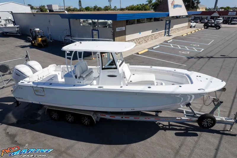 Slide: The Image of 2026 Sea Hunt Ultra 305 Coffin Box boat on trailer in parking lot. - 7