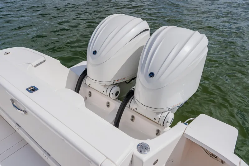 Slide: The Image of 2018 Intrepid 327 Center Console with dual outboard engines on water. - 100