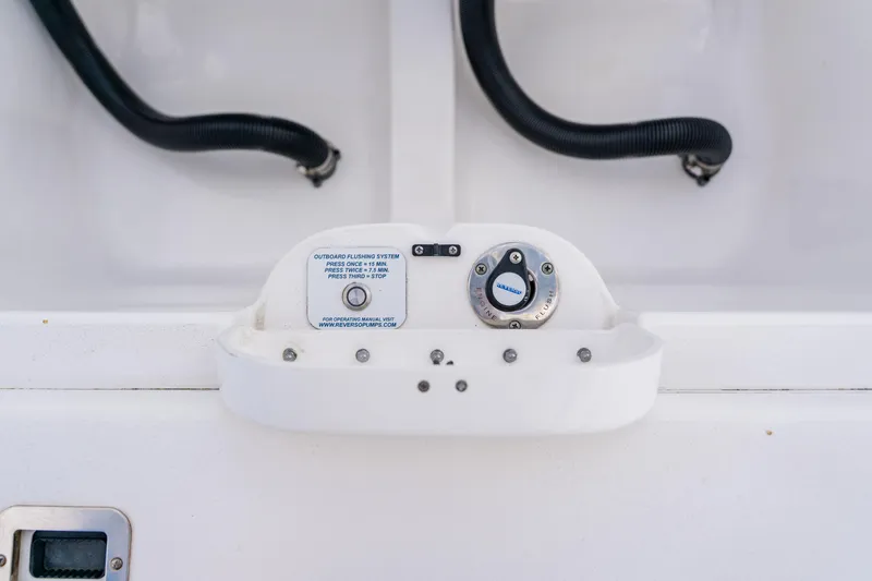 Slide: The Image of 2018 Intrepid 327 Center Console outboard flushing system with control panel and hoses. - 102