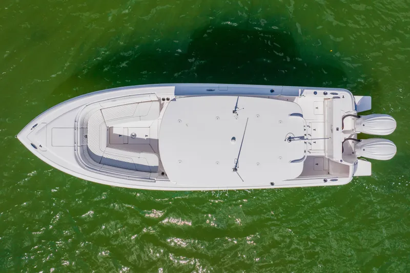 Slide: The Image of Overhead view of 2018 Intrepid 327 Center Console boat on green water. - 11