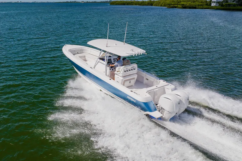 Slide: The Image of 2018 Intrepid 327 Center Console boat cruising on open water. - 12