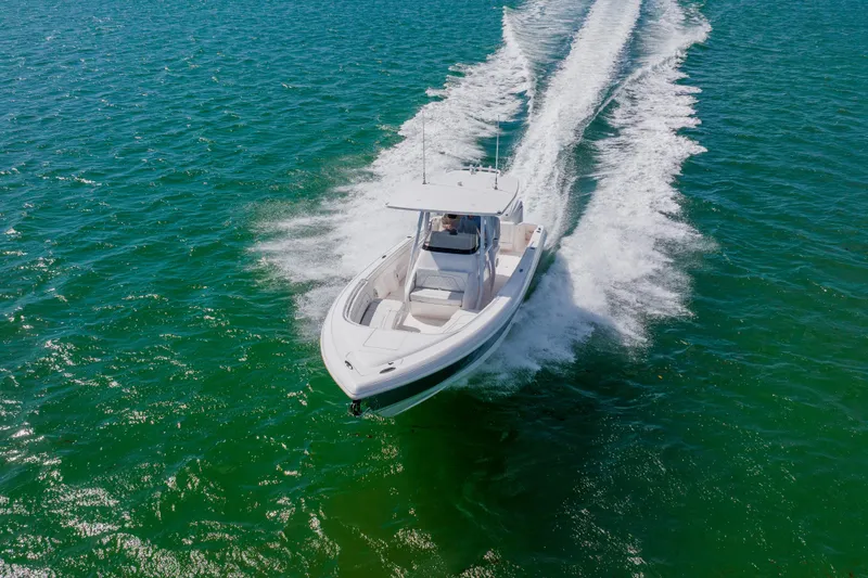 Slide: The Image of 2018 Intrepid 327 Center Console boat cruising on open water. - 17