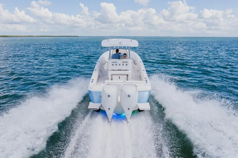 Slide: The Image of 2018 Intrepid 327 Center Console cruising on open water, rear view. - 19