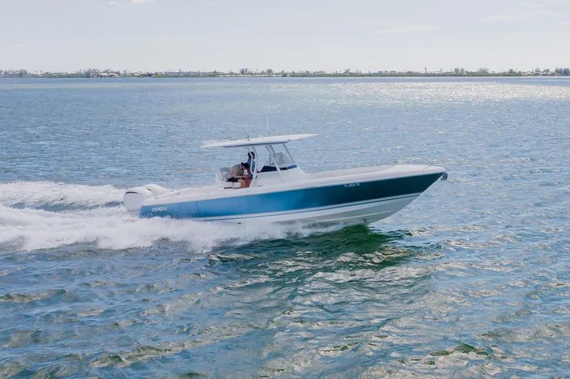 Slide: The Image of 2018 Intrepid 327 Center Console boat cruising on open water. - 23