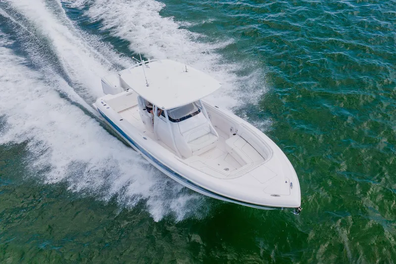 Slide: The Image of 2018 Intrepid 327 Center Console boat cruising on open water. - 24