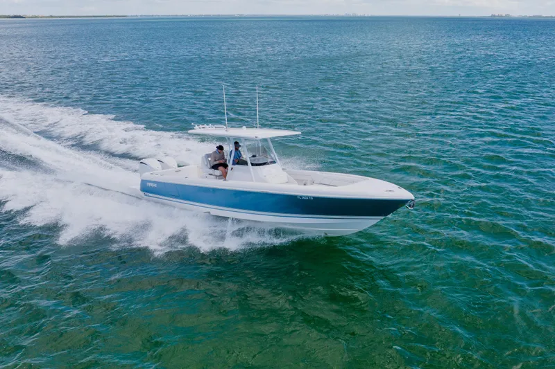 Slide: The Image of 2018 Intrepid 327 Center Console boat cruising on open water. - 25