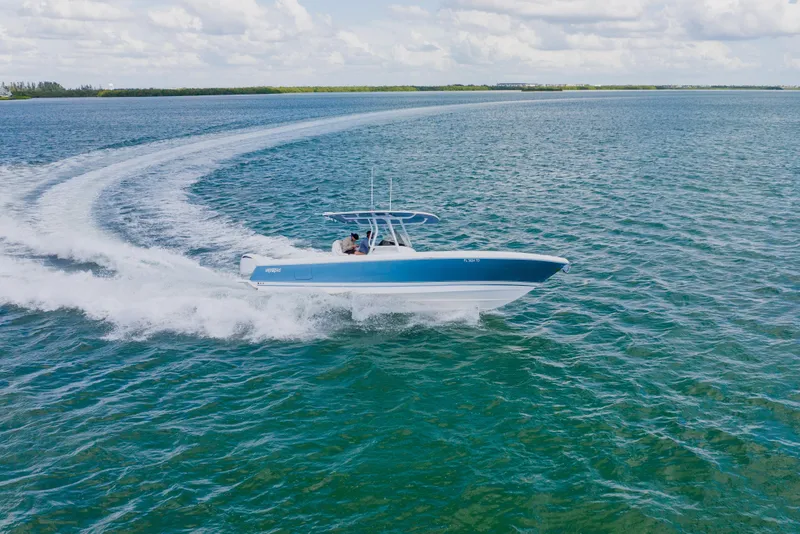 Slide: The Image of 2018 Intrepid 327 Center Console boat cruising on open water. - 26