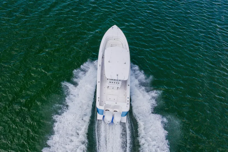 Slide: The Image of Aerial view of 2018 Intrepid 327 Center Console boat cruising on open water. - 28