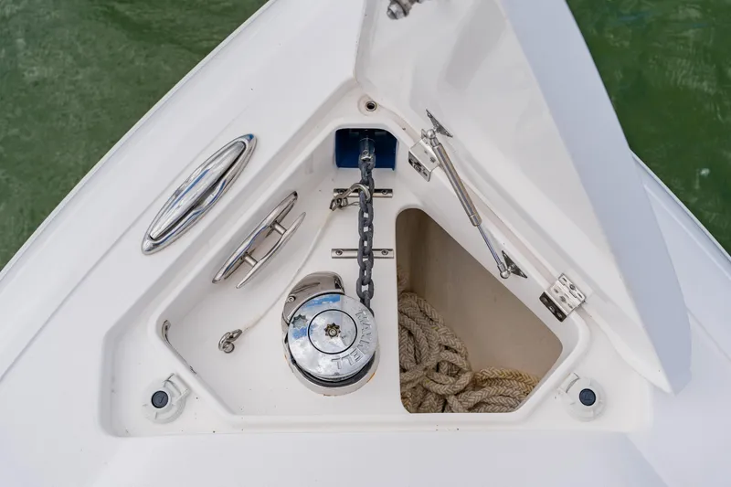 Slide: The Image of Anchor compartment of 2018 Intrepid 327 Center Console boat with chain and rope. - 30