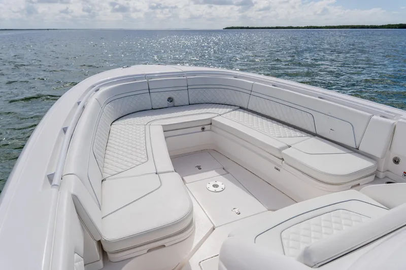 Slide: The Image of 2018 Intrepid 327 Center Console boat with spacious seating on calm waters. - 34