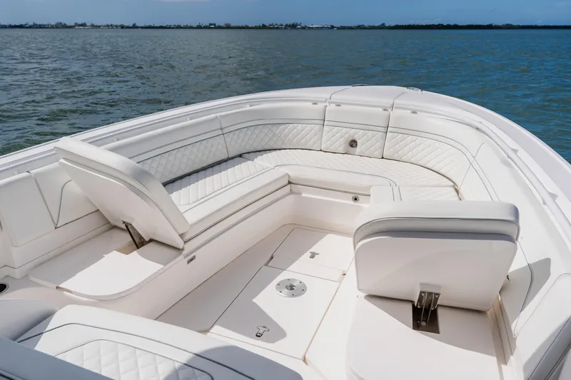 Slide: The Image of 2018 Intrepid 327 Center Console boat with luxurious white seating on open water. - 38