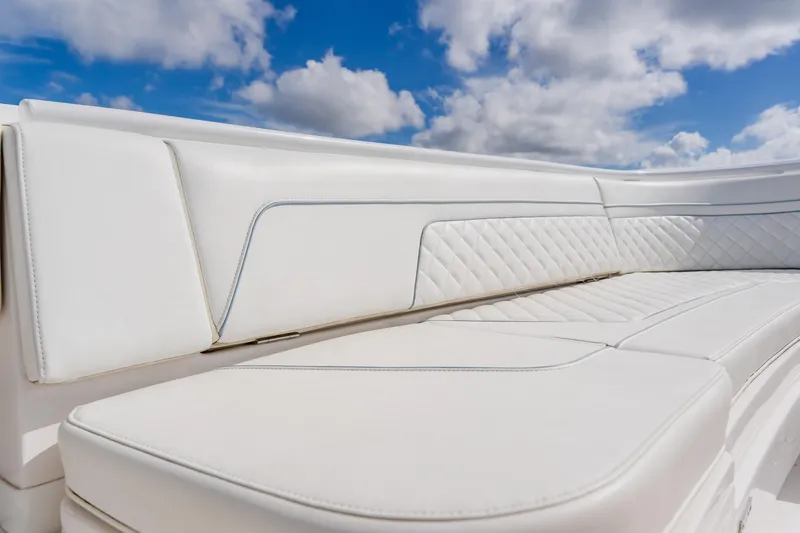 Slide: The Image of Luxurious white seating on 2018 Intrepid 327 Center Console boat under blue sky. - 41