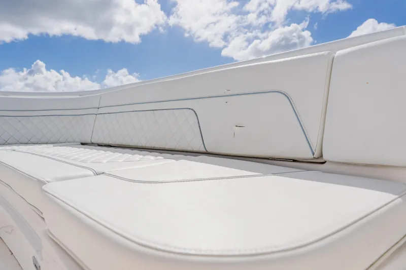 Slide: The Image of 2018 Intrepid 327 Center Console boat seating under a bright blue sky. - 42
