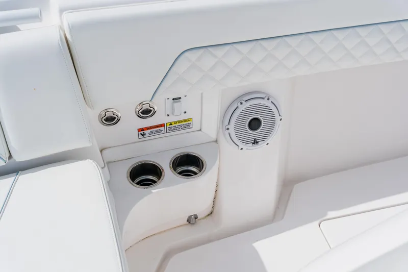 Slide: The Image of 2018 Intrepid 327 Center Console interior with cup holders and speaker. - 44