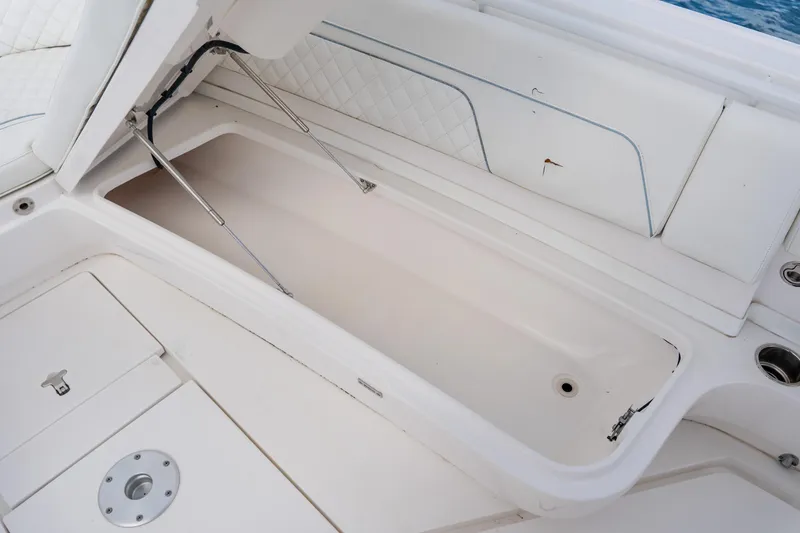 Slide: The Image of Open storage compartment on 2018 Intrepid 327 Center Console boat. - 46