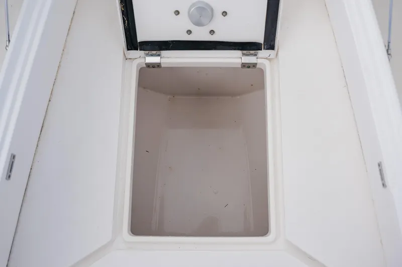Slide: The Image of Open storage compartment on a 2018 Intrepid 327 Center Console boat. - 51