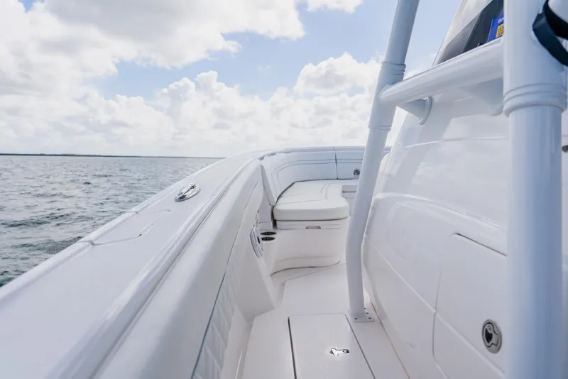 Slide: The Image of 2018 Intrepid 327 Center Console boat on open water under a cloudy sky. - 52
