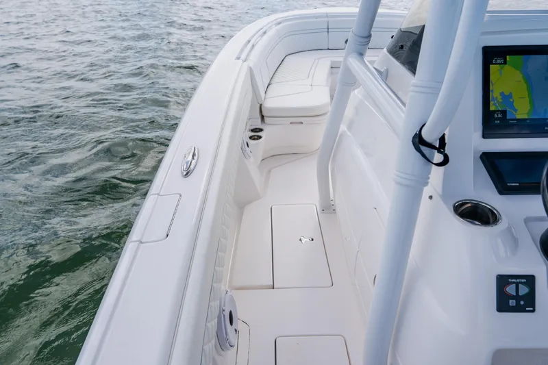 Slide: The Image of 2018 Intrepid 327 Center Console boat interior with navigation display, on calm water. - 57