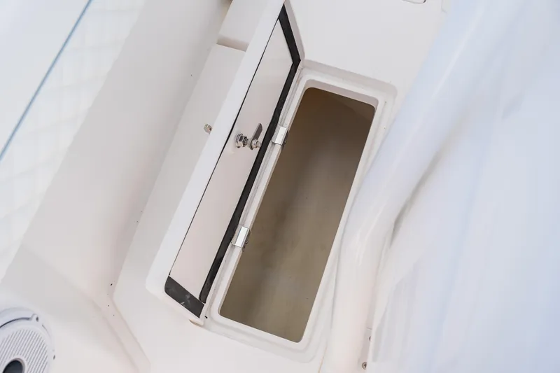 Slide: The Image of Open storage compartment on 2018 Intrepid 327 Center Console boat. - 60