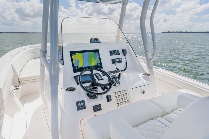 Slide: The Image of 2018 Intrepid 327 Center Console boat interior with navigation system on open water. - 61