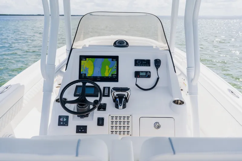 Slide: The Image of 2018 Intrepid 327 Center Console boat dashboard with navigation system and steering wheel. - 62