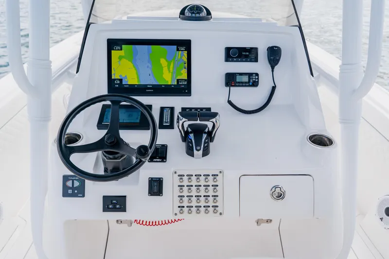 Slide: The Image of 2018 Intrepid 327 Center Console helm with navigation display and controls. - 64