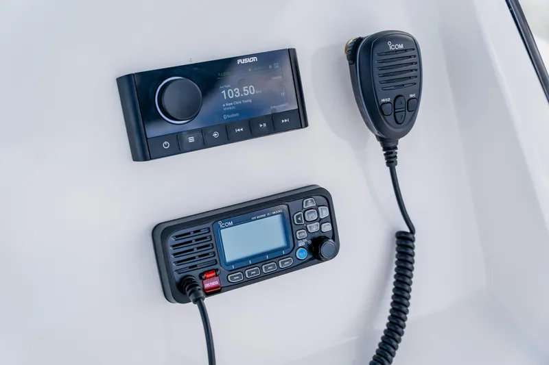 Slide: The Image of Control panel of a 2018 Intrepid 327 Center Console with radio and communication devices. - 68