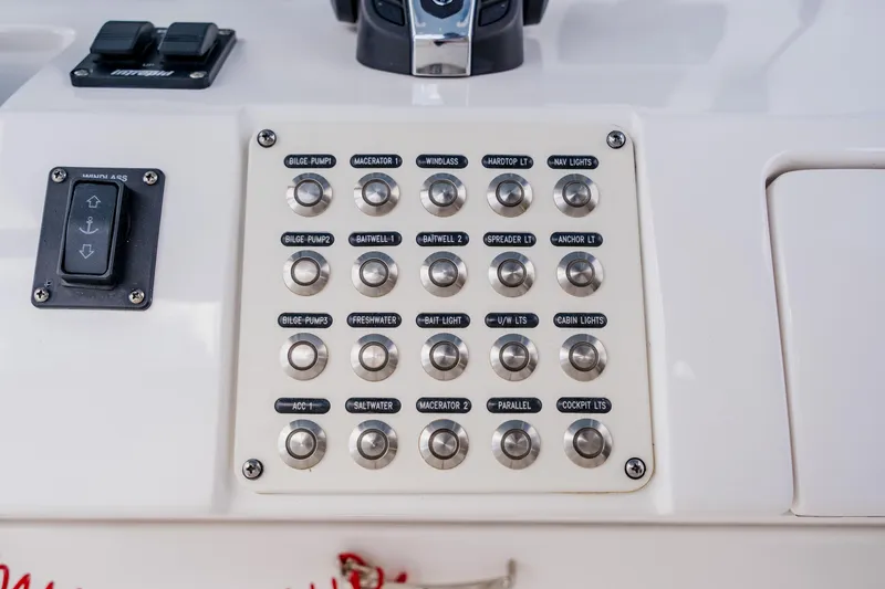 Slide: The Image of Control panel of a 2018 Intrepid 327 Center Console boat with labeled switches. - 69
