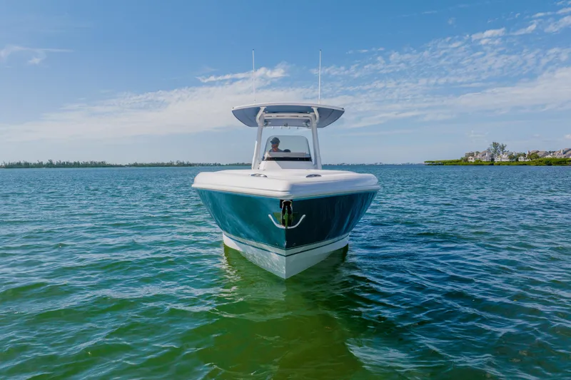 Slide: The Image of 2018 Intrepid 327 Center Console boat on calm blue water under clear sky. - 7