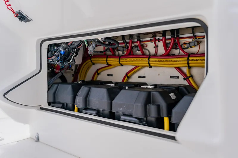 Slide: The Image of 2018 Intrepid 327 Center Console battery compartment with organized wiring and secure battery boxes. - 70