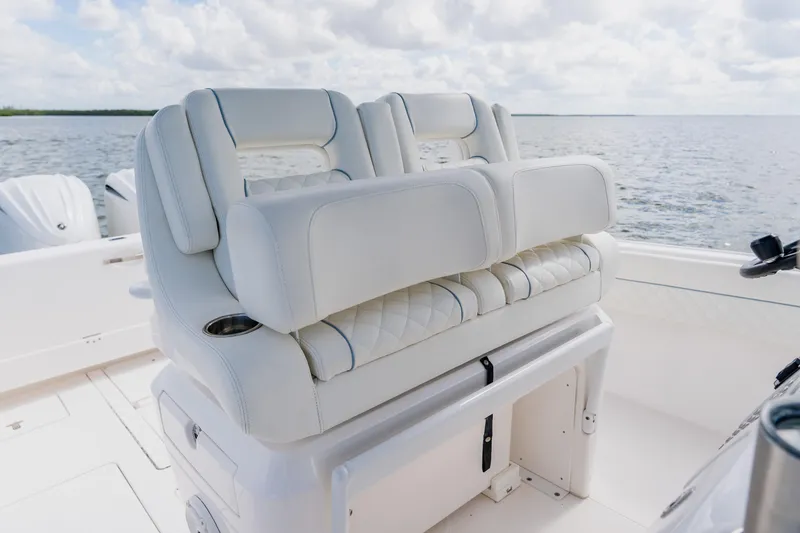 Slide: The Image of 2018 Intrepid 327 Center Console boat with luxurious white seating on open water. - 72