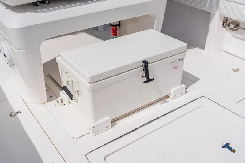 Slide: The Image of 2018 Intrepid 327 Center Console with secured white storage box on deck. - 76