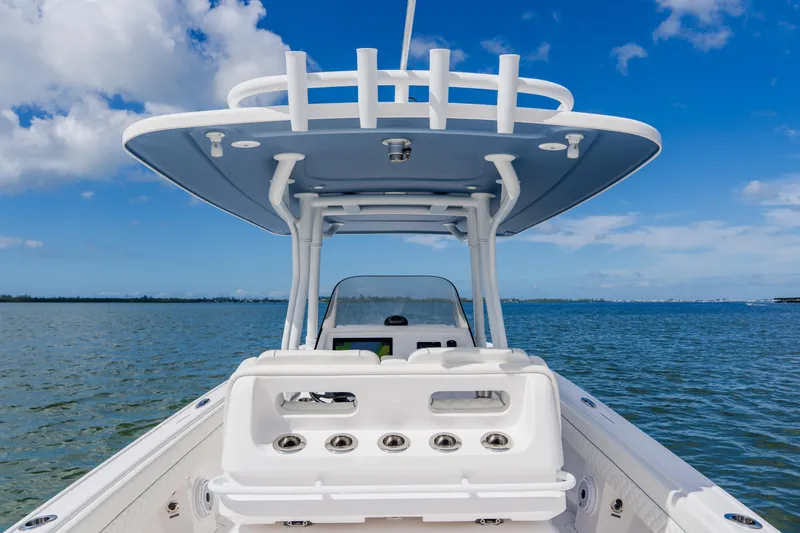 Slide: The Image of 2018 Intrepid 327 Center Console boat on calm water under blue sky. - 78