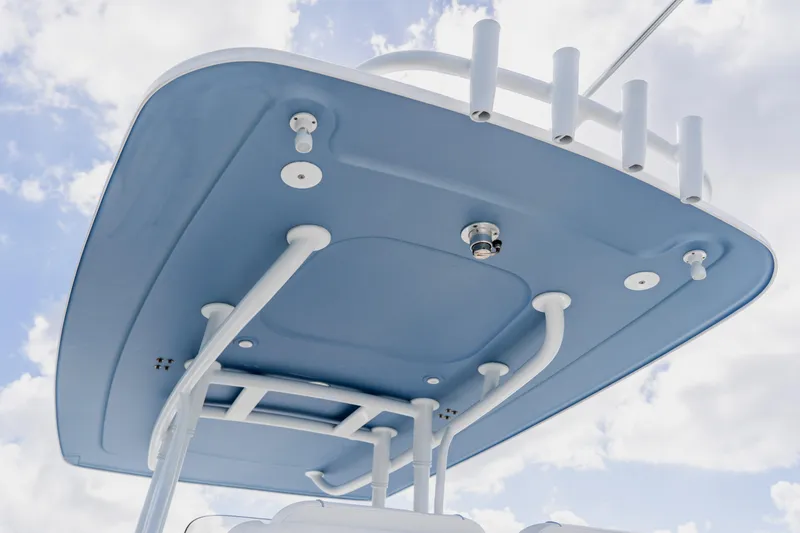Slide: The Image of 2018 Intrepid 327 Center Console boat's blue T-top against a cloudy sky. - 79