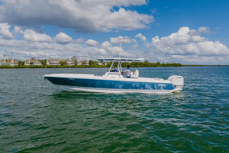 Slide: The Image of 2018 Intrepid 327 Center Console boat cruising on a sunny day. - 8