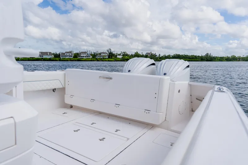 Slide: The Image of 2018 Intrepid 327 Center Console boat with dual engines on a calm lake. - 81