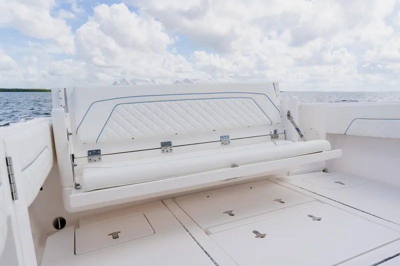 Slide: The Image of 2018 Intrepid 327 Center Console boat with white seating and ocean backdrop. - 88