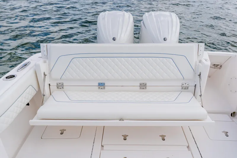 Slide: The Image of 2018 Intrepid 327 Center Console boat with white cushioned seating and dual engines. - 89