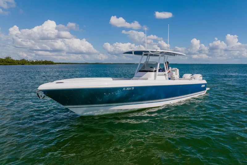 Slide: The Image of 2018 Intrepid 327 Center Console boat on calm blue waters under a clear sky. - 9