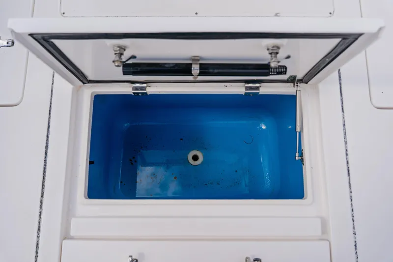 Slide: The Image of Open storage compartment on 2018 Intrepid 327 Center Console boat. - 91