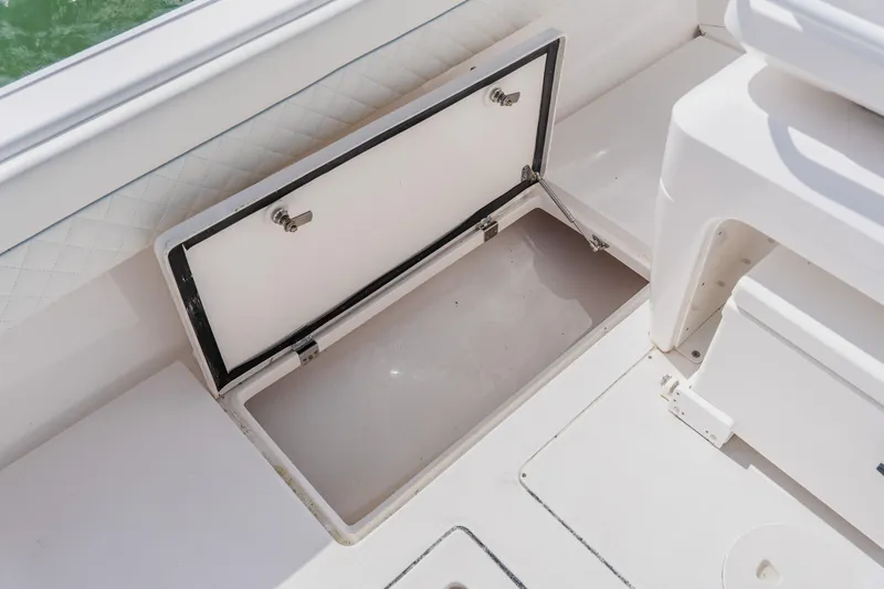 Slide: The Image of Open storage compartment on 2018 Intrepid 327 Center Console boat. - 95
