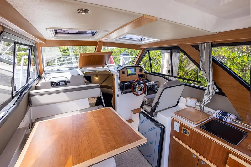 Slide: The Image of Manufacturer Provided Image: Interior of 2025 Cutwater C-248 Coupe boat with modern amenities and wood finishes. - 8