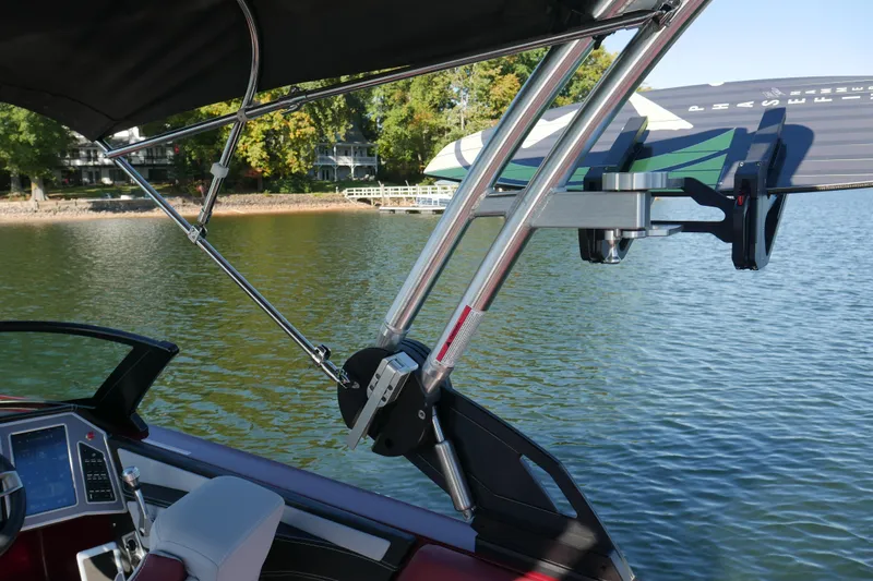 Slide: The Image of 2022 MasterCraft X22 boat with wakeboard rack on a calm lake. - 25