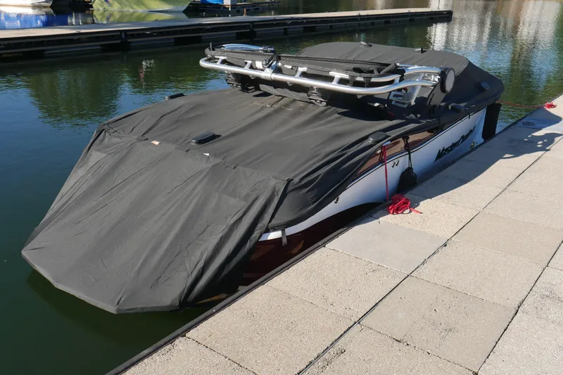 Slide: The Image of 2022 MasterCraft X22 boat covered at dockside, ready for storage. - 27