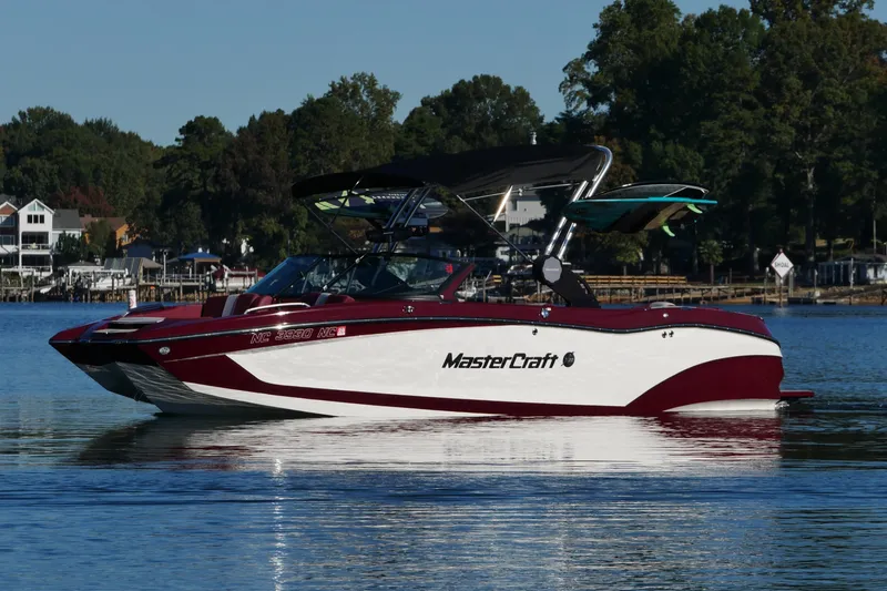 Slide: The Image of 2022 MasterCraft X22 boat on a calm lake with scenic background. - 7