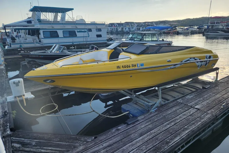 The Image of 2003 Crownline 225 LPX boat in vibrant yellow docked at a marina. - 0