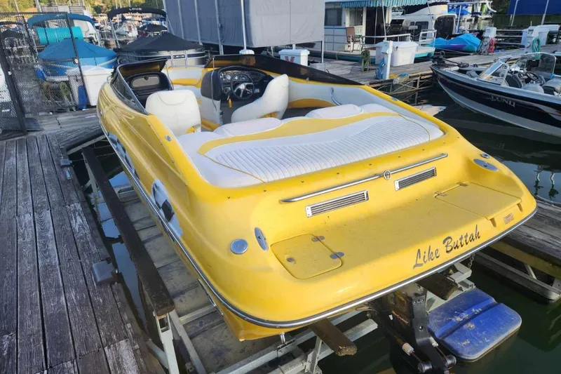 Slide: The Image of Yellow 2003 Crownline 225 LPX boat docked at marina, rear view. - 3
