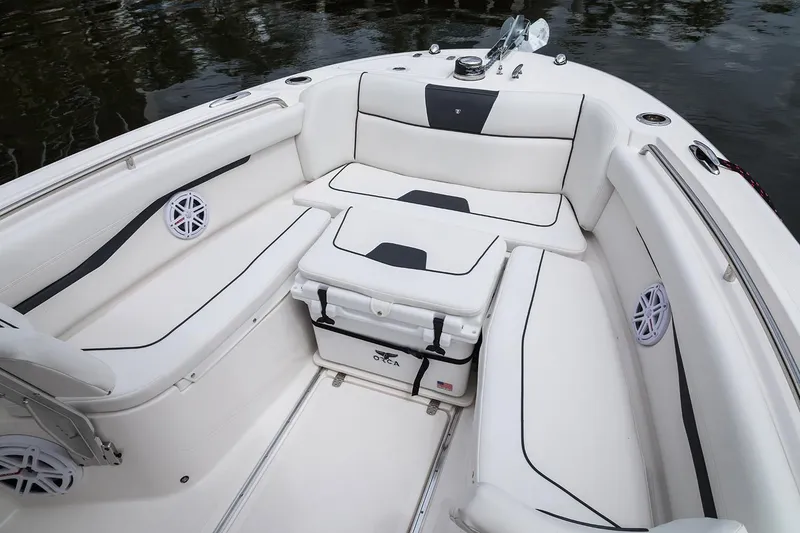 Slide: The Image of 2019 Wellcraft 262 Fisherman boat interior with cushioned seating and storage. - 57