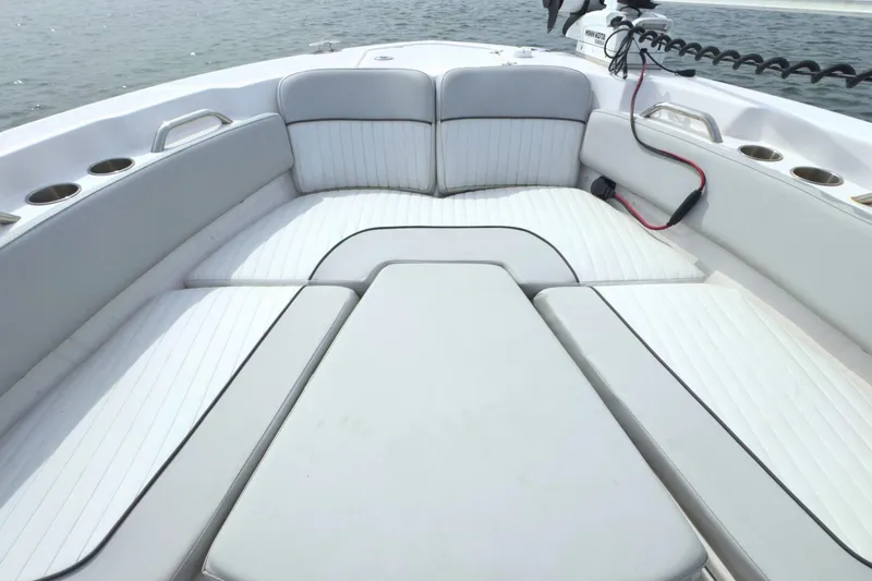 Slide: The Image of 2022 Sea Fox 248 Commander boat interior with cushioned seating and cup holders. - 29
