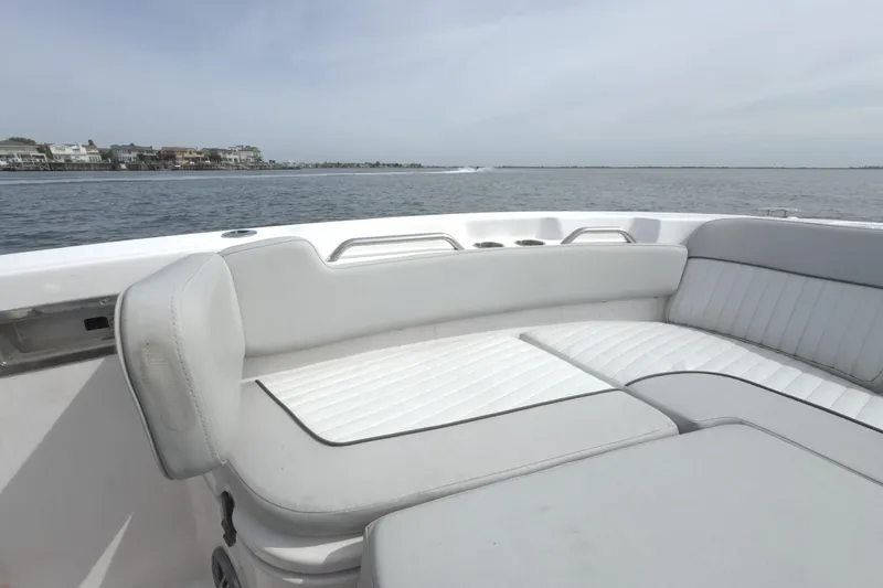 Slide: The Image of 2022 Sea Fox 248 Commander boat interior with white seating, ocean view. - 32